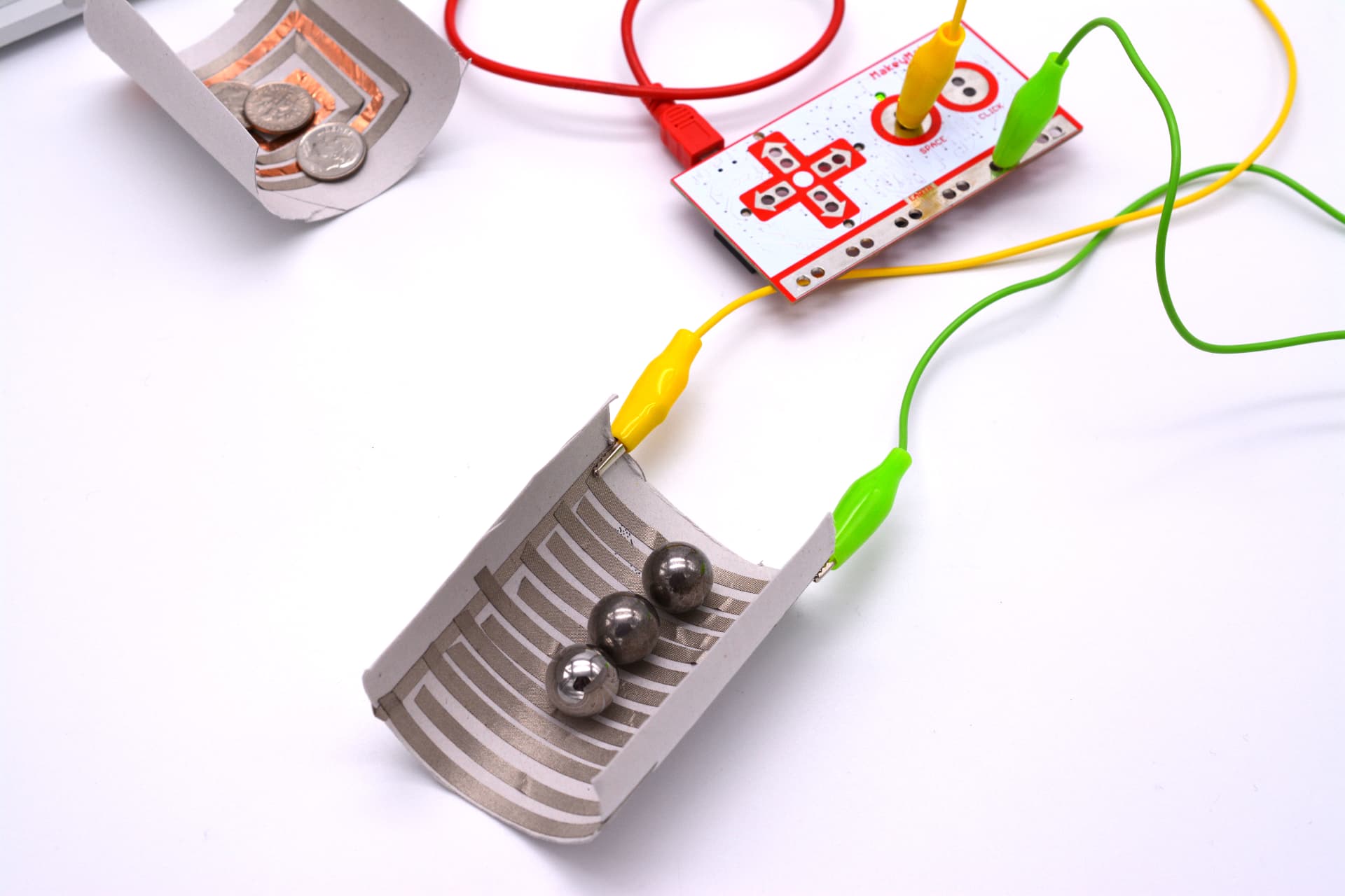 Cardboard coils with steel balls wired to a Makey Makey to test conductivity
