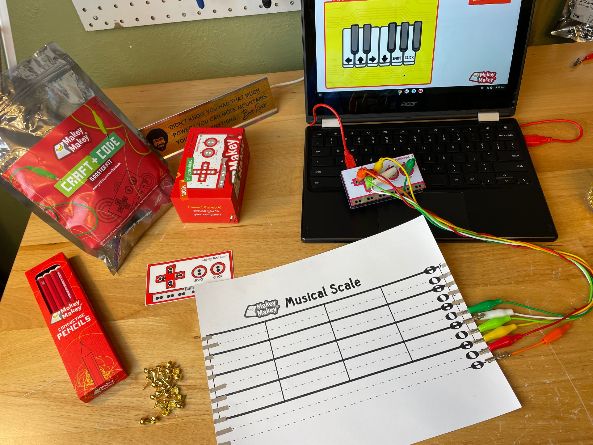 A musical scale worksheet wired to a Makey Makey board and laptop